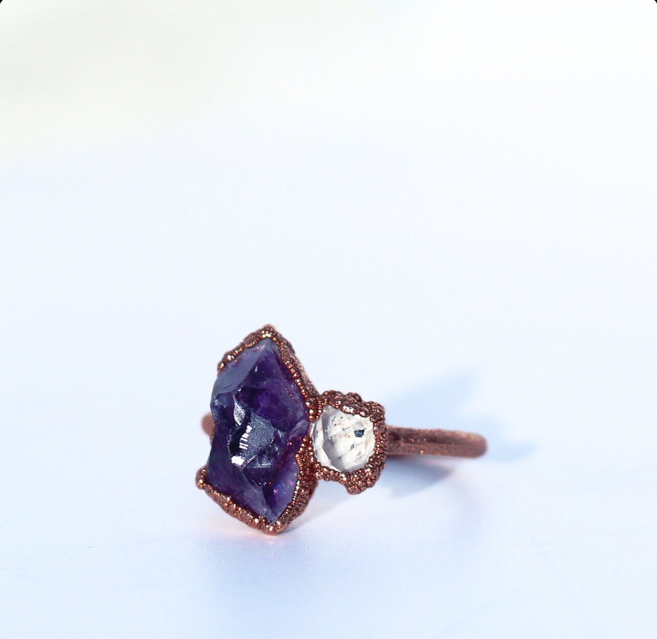 A rough, purple amethyst is paired with a tiny Herkimer diamond in this luxe and organic crown chakra ring. Stones are set in copper on a pure, solid copper band.