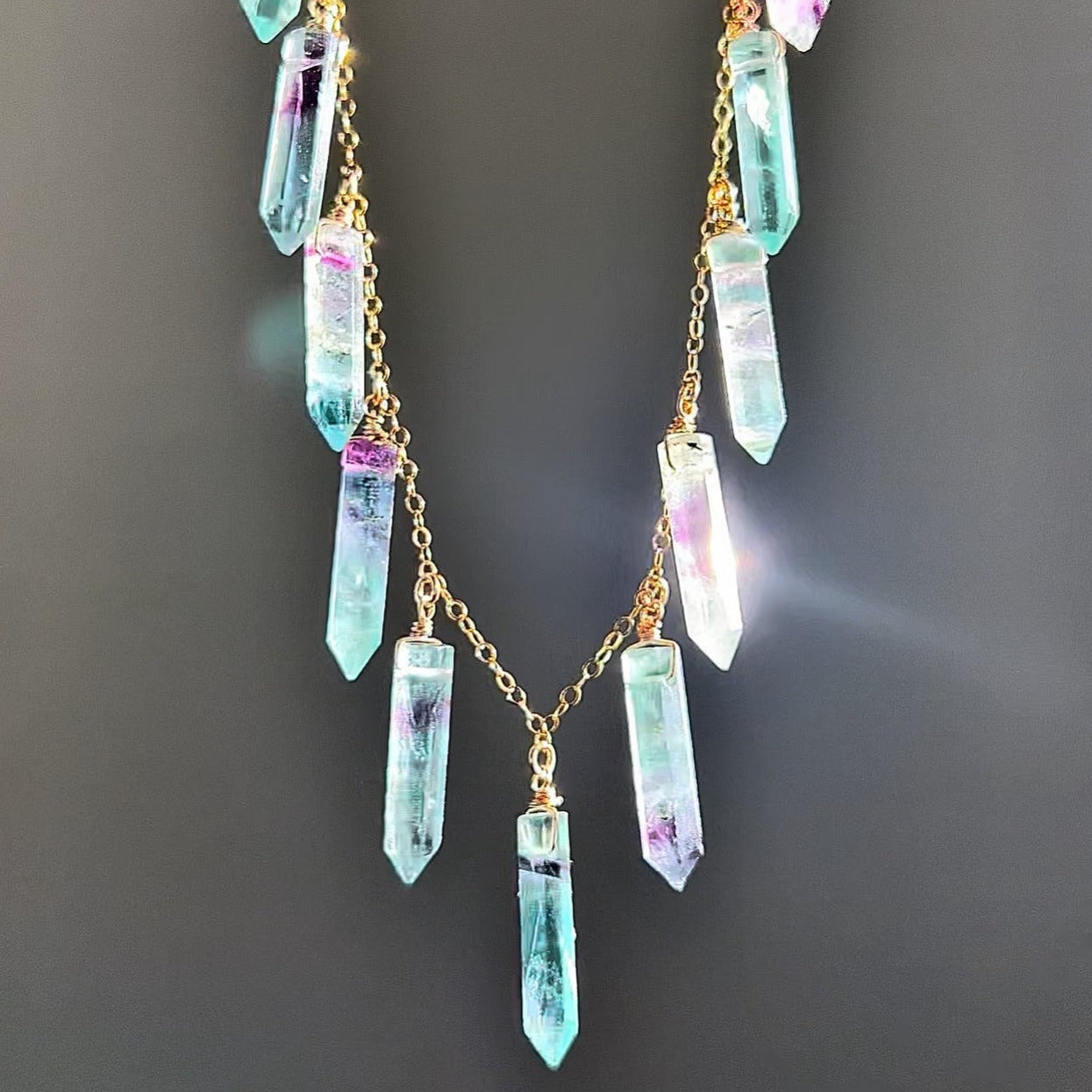 This multi stone crystal necklace features 11 natural, mini crystals that have been wire wrapped by hand and dangle from a sparkling chain in the metal of your choice. You get to pick 14k gold filled, 14k rose gold filled or sterling silver metal as well as your pick of crystal- rose quartz, smoky quartz, amethyst or crystal quartz.