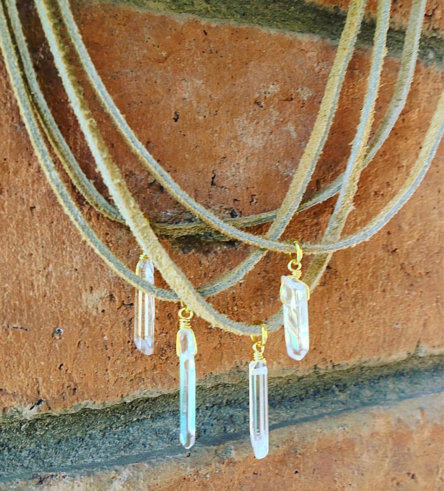 Crystal Choker on Tan Suede, A delicate crystal point in your choice is wrapped with gold or silver wire and sparkles in the center of this tan suede choker.