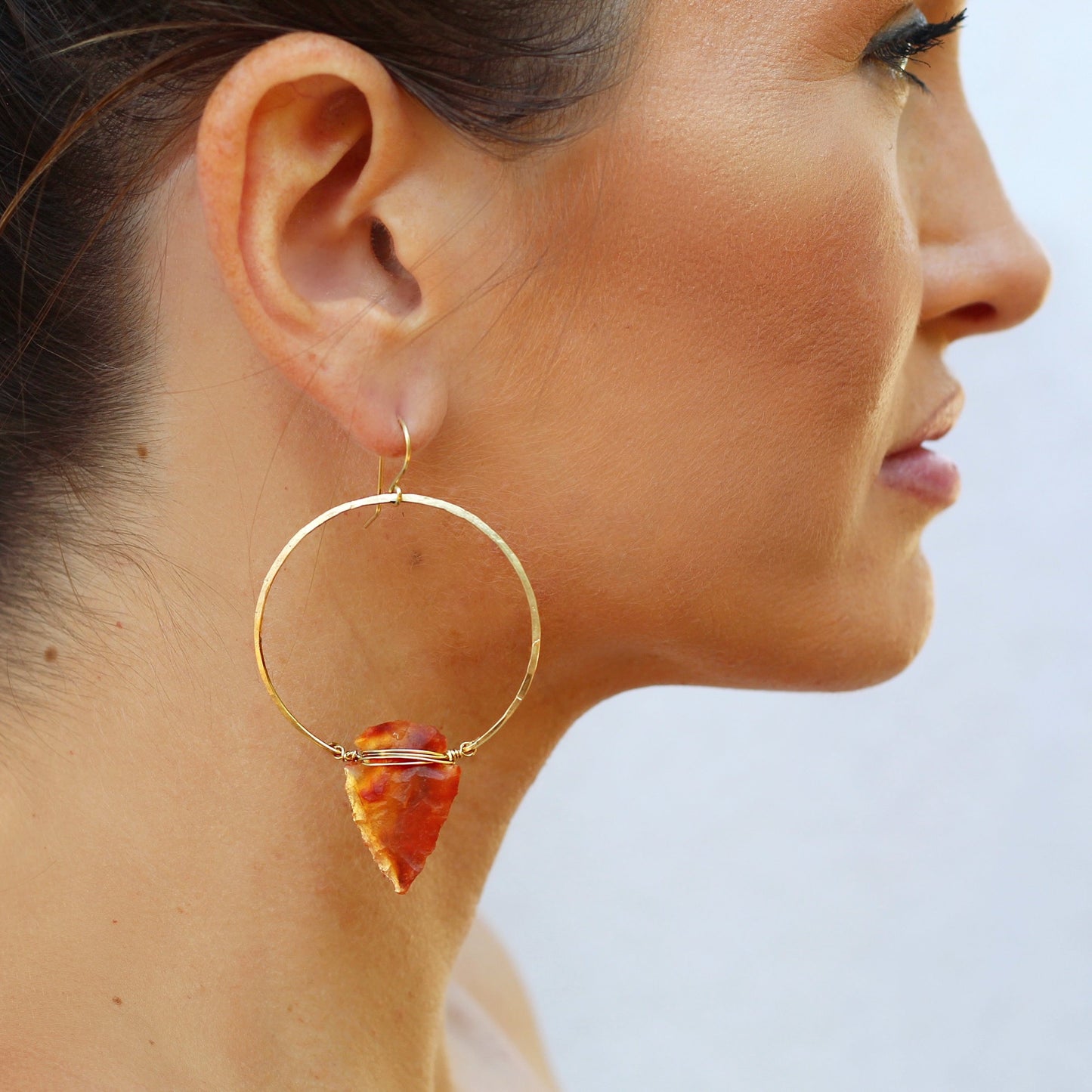 girl wearing carnelian arrowhead hoop earrings