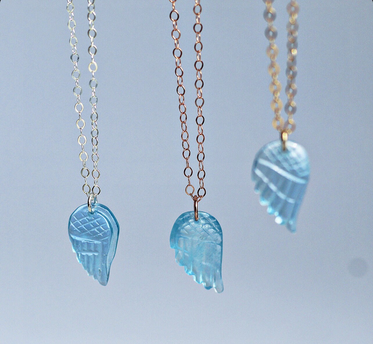 This sweet and dainty angel wing necklace features a carved aquamarine pendant that hangs from delicate, sparkling chain in your choice of 14k gold filled, 14k rose gold filled or sterling silver chain.