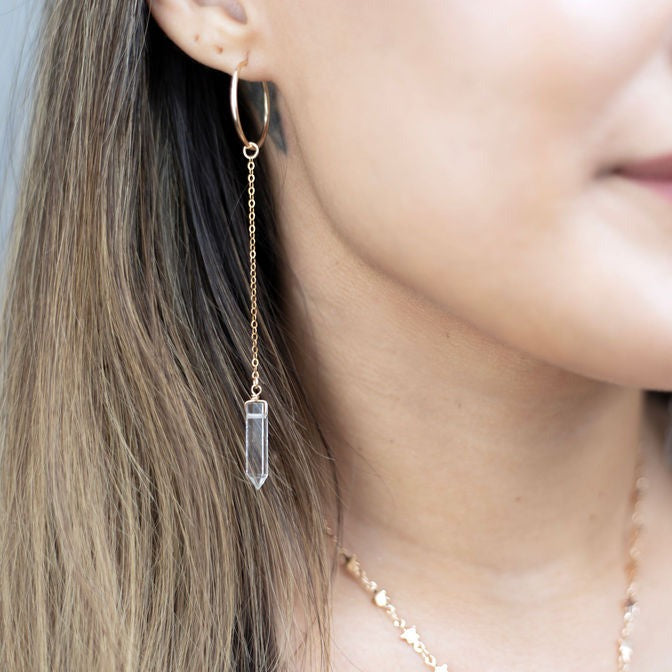 Genuine crystal points are wire wrapped by hand and dangle from a lightweight hoop, creating a delicate, boho style statement earring.