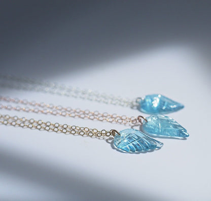 This sweet and dainty angel wing necklace features a carved aquamarine pendant that hangs from delicate, sparkling chain in your choice of 14k gold filled, 14k rose gold filled or sterling silver chain.