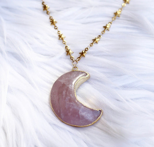 This celestial crystal necklace features a genuine, rose quartz carved moon that is electroformed with gold or silver and attached to your choice of pure stainless steel or gold tone stainless steel tiny star link chain.