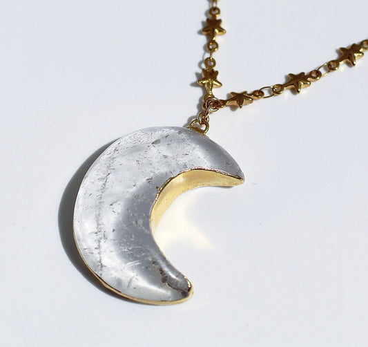 This celestial crystal necklace features a genuine, clear quartz carved moon pendant that is electroformed with gold or silver and attached to your choice of pure stainless steel or gold tone stainless steel tiny star link chain.